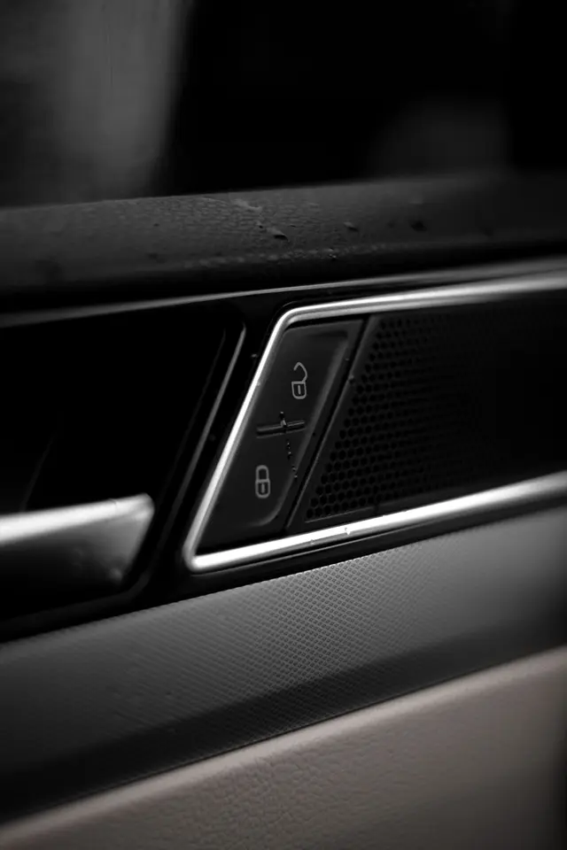 Power door lock and unlock buttons on a car door panel
