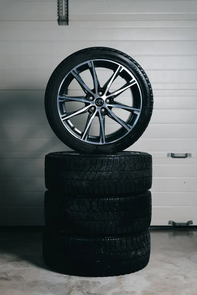 Stacked car tires with an alloy wheel on top